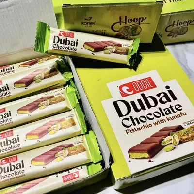 Boxes of Oodie Dubai Chocolate bars with pistachio and kunafa filling, neatly arranged for display.