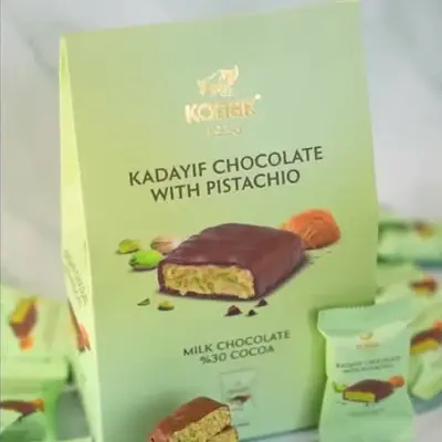 Box of Kadayif Chocolate with Pistachio featuring milk chocolate and 30% cocoa, surrounded by individually wrapped pieces.