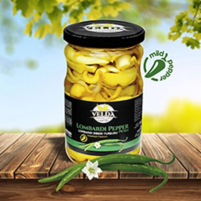 Velda Lombardi Pepper Pickle jar placed on a wooden table with a mild pepper label and a vibrant outdoor setting.